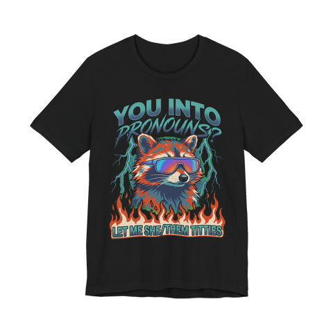 Raccoon in rainbow shades over flames with the pronoun joke LET ME SHE/THEM TITTIES, on a t-shirt — Black