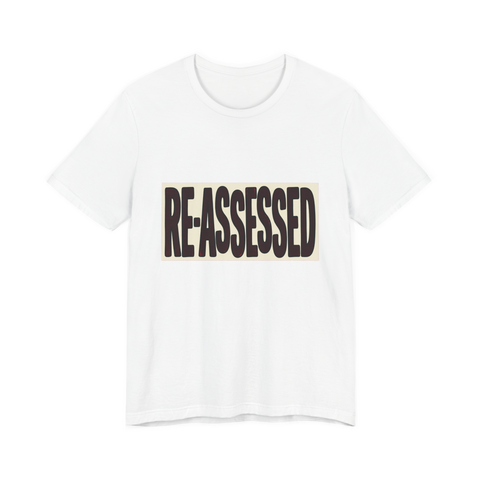 RE-ASSESSED Stamp T-Shirt — Funny Dystopian Bureaucracy Tee — White