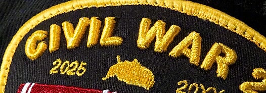 Macro: the dates 2025 and 20XX flanking a small gold upside-down United States